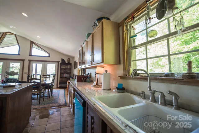 a kitchen with a sink and a large window