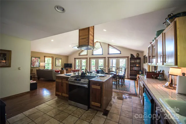 a living room with lots of furniture and a large window