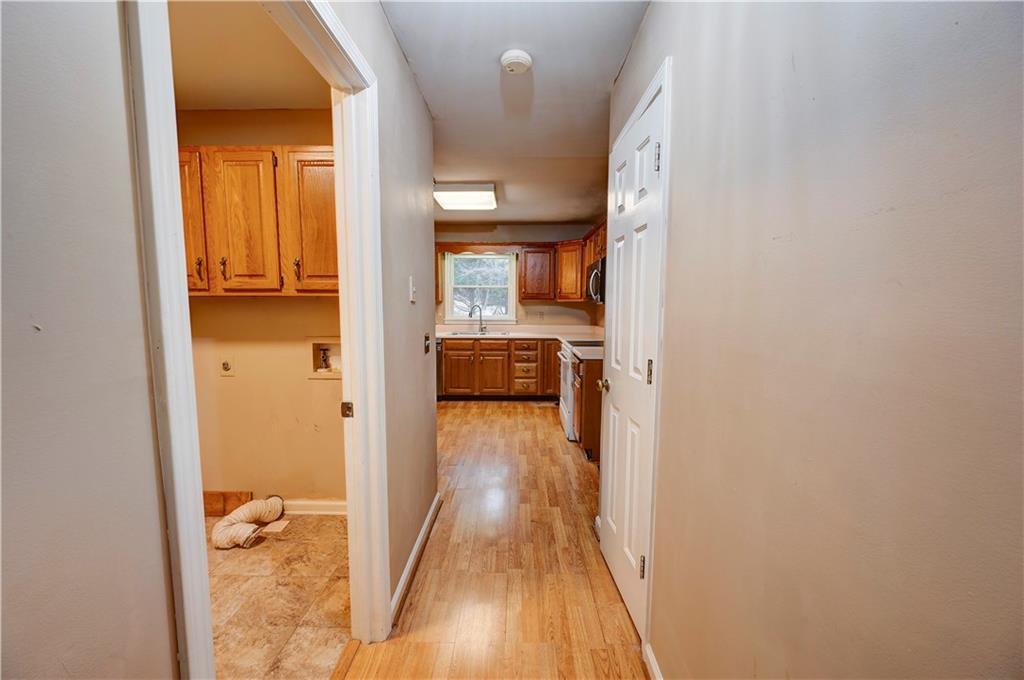 197 Saddlebrook Drive Southeast Calhoun, GA 30701 - Photo 12 of 71 a view of a hallway with wooden floor and a livingroom with wooden floor