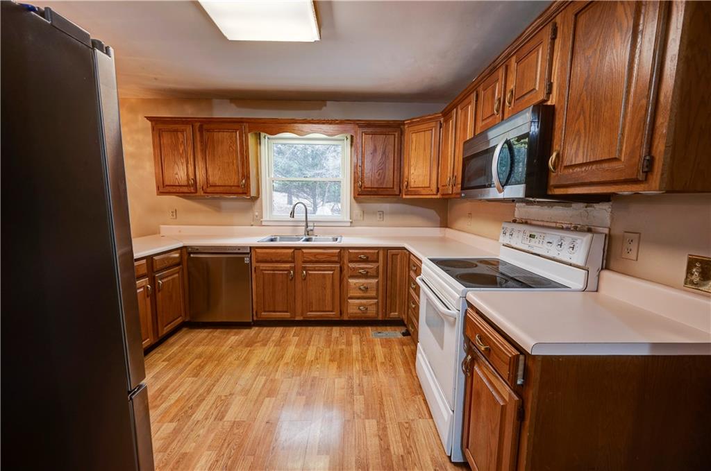 197 Saddlebrook Drive Southeast Calhoun, GA 30701 - Photo 16 of 71 a kitchen with stainless steel appliances sink a stove and a refrigerator