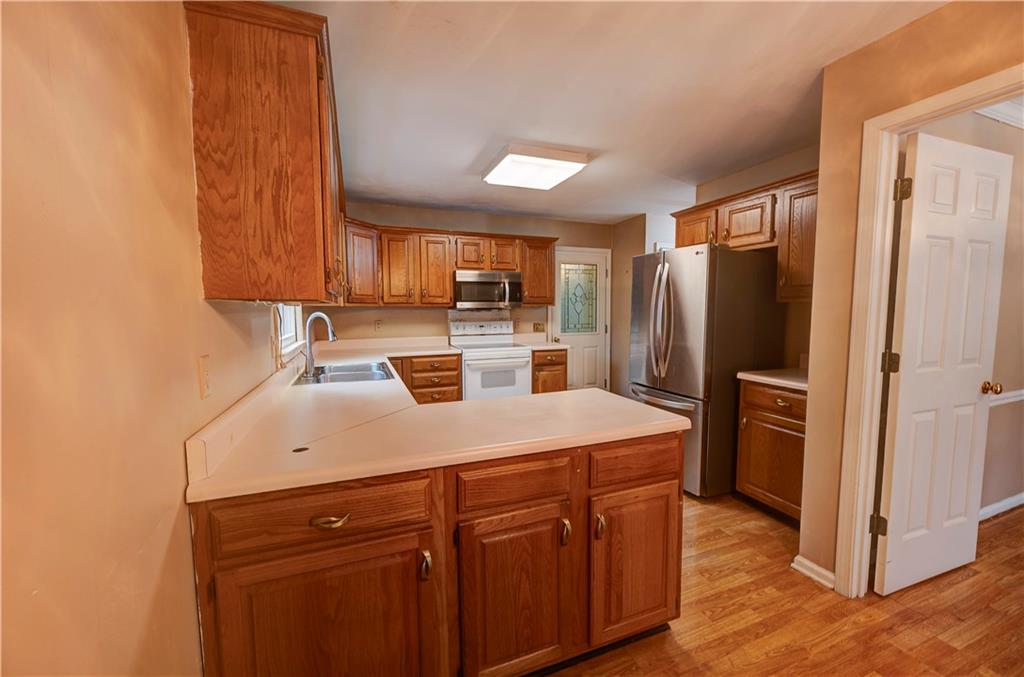 197 Saddlebrook Drive Southeast Calhoun, GA 30701 - Photo 21 of 71 a kitchen with a refrigerator sink and cabinets