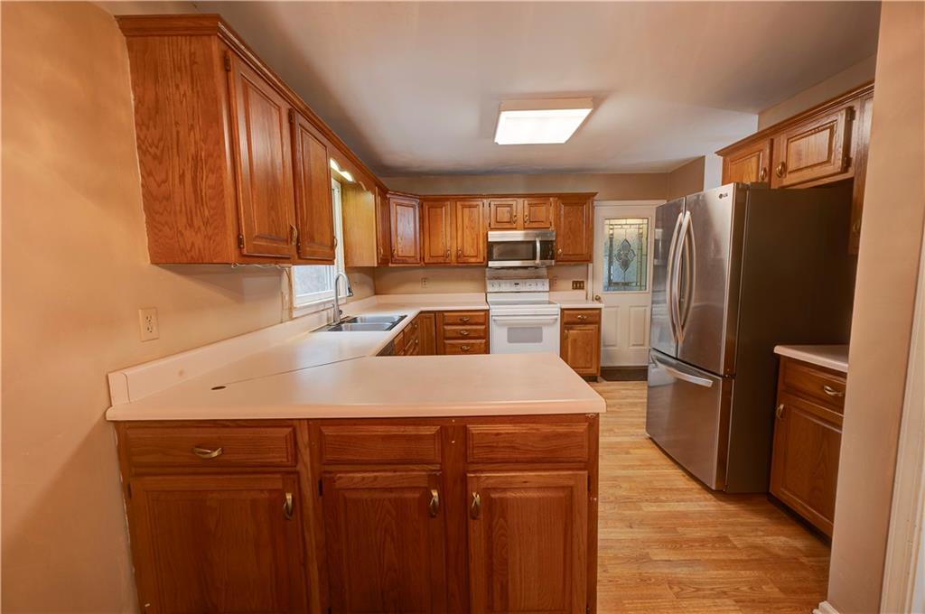 197 Saddlebrook Drive Southeast Calhoun, GA 30701 - Photo 22 of 71 a kitchen with a refrigerator sink and stove