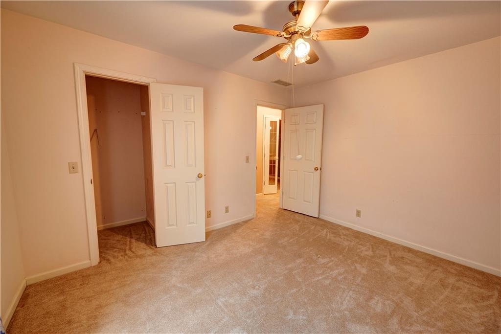 197 Saddlebrook Drive Southeast Calhoun, GA 30701 - Photo 57 of 71 an empty room with a ceiling fan and a window