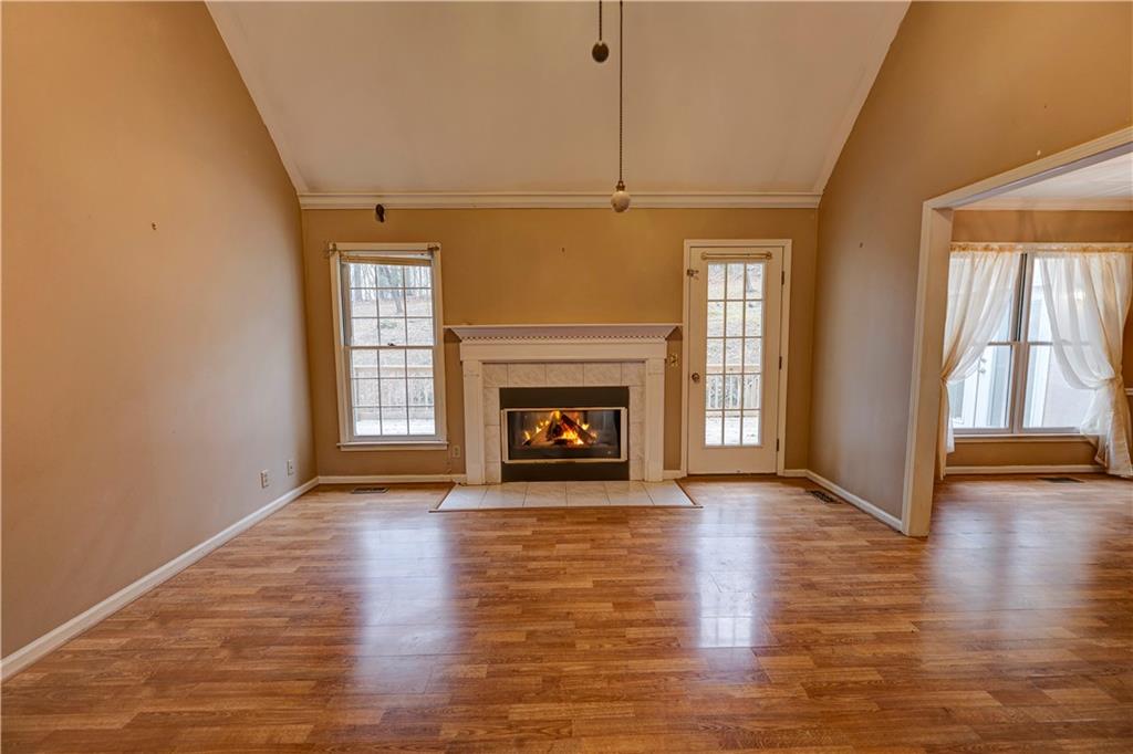 197 Saddlebrook Drive Southeast Calhoun, GA 30701 - Photo 7 of 71 a view of an empty room with wooden floor fireplace and a window