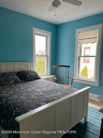 a bed sitting in a bedroom next to a window