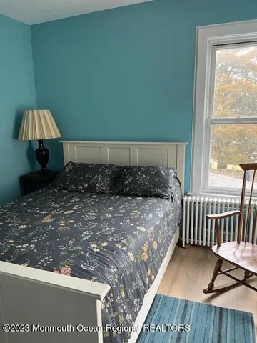 a bed sitting in a bedroom next to a window