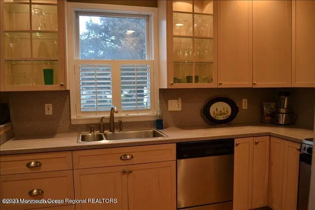 a sink with a cabinet and mirror