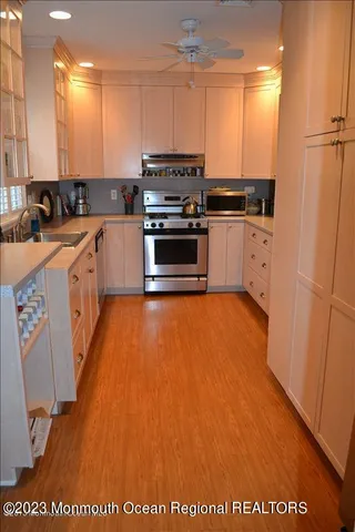 a kitchen with stainless steel appliances granite countertop a stove a sink and a refrigerator
