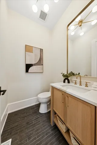 a bathroom with a sink mirror and toilet