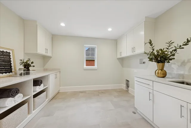 a view of a kitchen with white cabinets