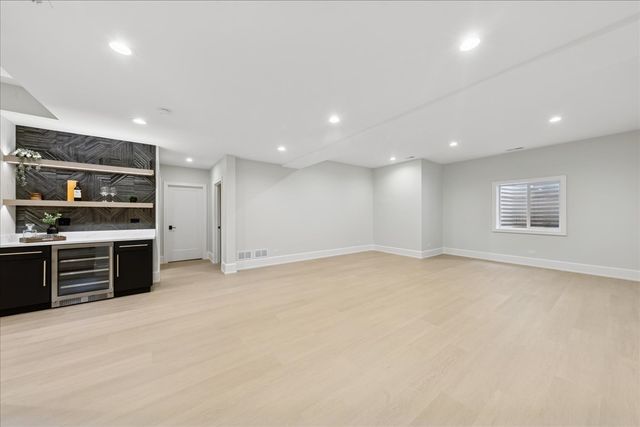 an empty room with kitchen appliances and windows