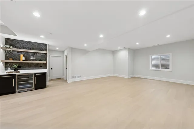 an empty room with kitchen appliances and windows