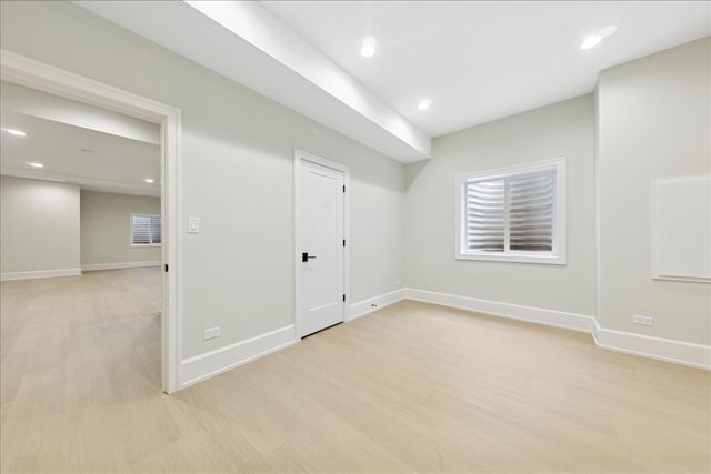 an empty room with windows and closet