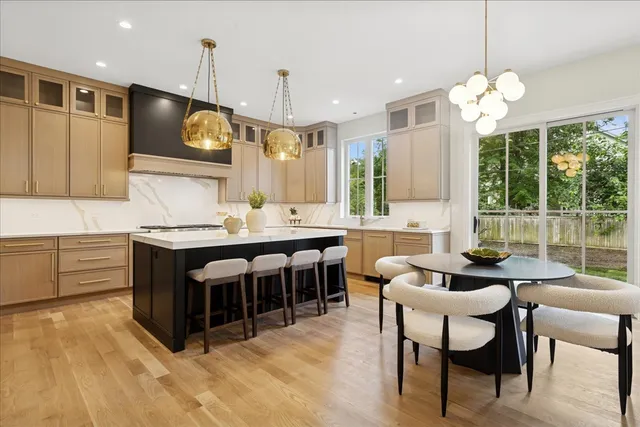 a kitchen with kitchen island granite countertop a sink counter and chairs