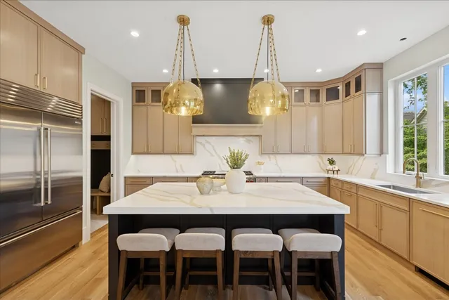 a kitchen with a dining table chairs and refrigerator