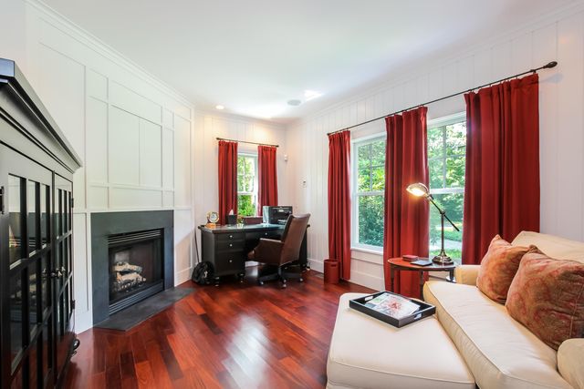 a living room with furniture fireplace and flat screen tv