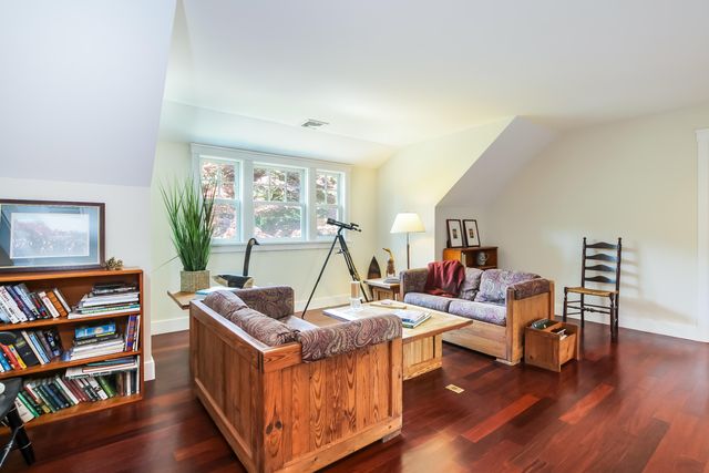 a living room with furniture and a book shelf