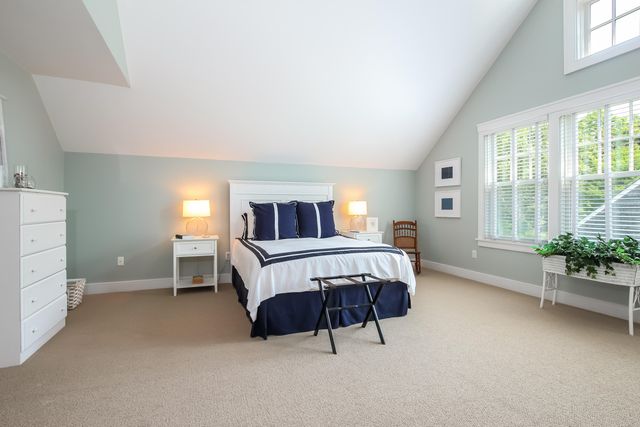 a bedroom with a bed and a potted plant