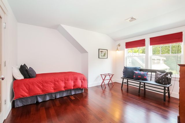 a bedroom with furniture and a large window
