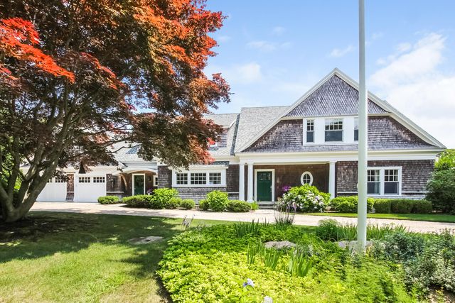 a front view of a house with a yard table and chairs