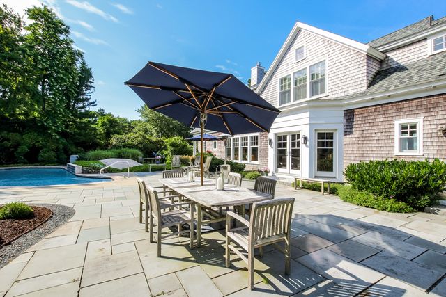a view of a patio with table and chairs and potted plants