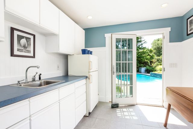 a kitchen with a sink a refrigerator and window