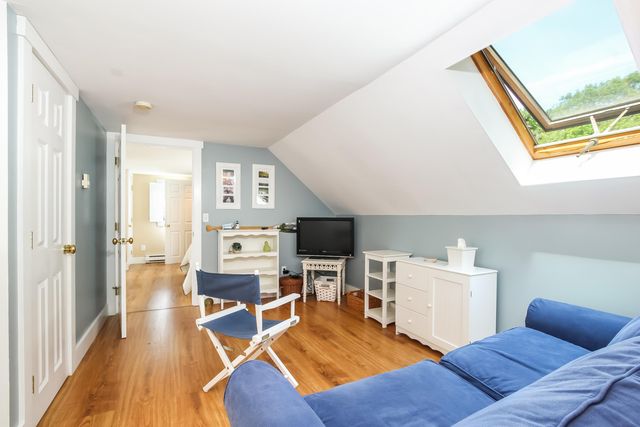 a living room with furniture a flat screen tv and a table