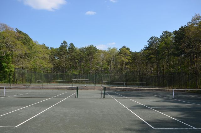 a view of a house with a backyard and sitting area