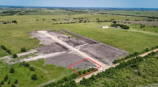 an aerial view of a houses with a yard
