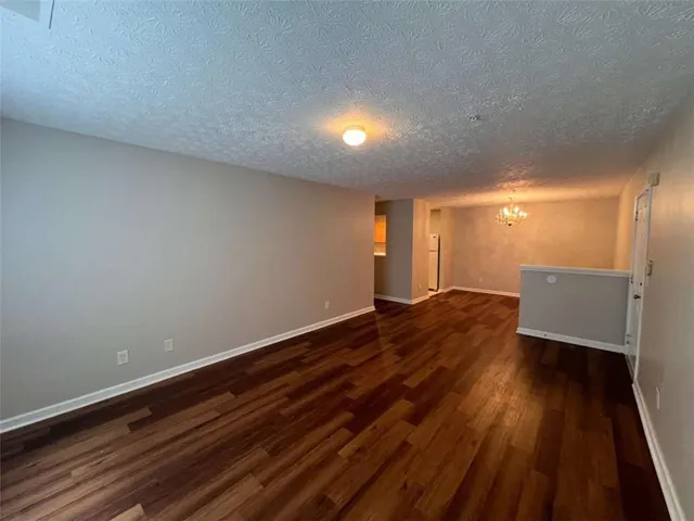 a view of room with window and wooden floor