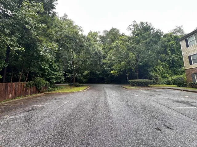 a view of a backyard with large trees