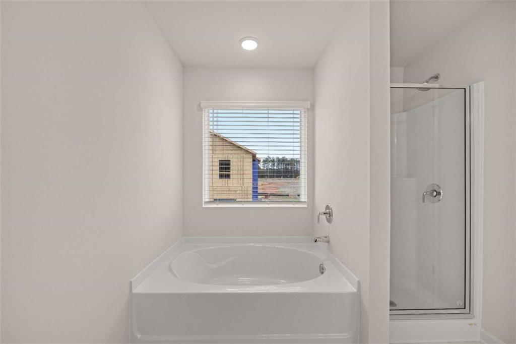 9452 Maple Grv Lane Jonesboro, GA 30238 - Photo 11 of 23 a white bath tub sitting next to a window