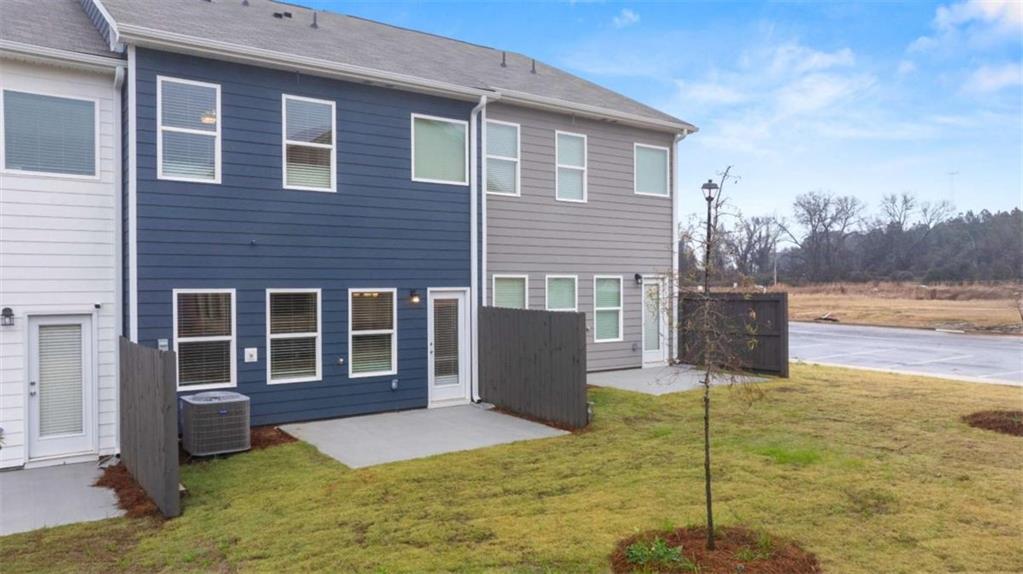 9452 Maple Grv Lane Jonesboro, GA 30238 - Photo 20 of 23 a backyard of a house with yard and outdoor seating