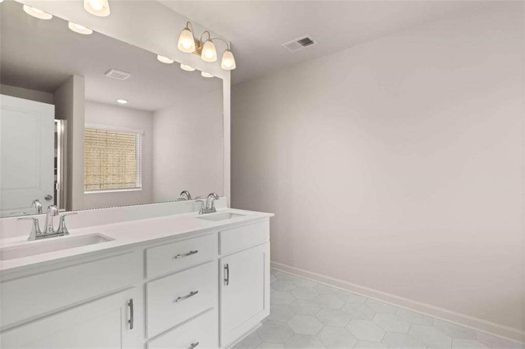 9452 Maple Grv Lane Jonesboro, GA 30238 - Photo 22 of 23 a bathroom with a sink and a mirror