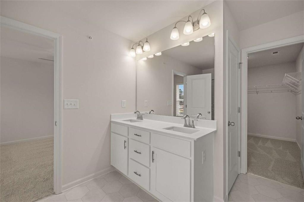 9452 Maple Grv Lane Jonesboro, GA 30238 - Photo 23 of 23 a bathroom with a double vanity sink and a mirror