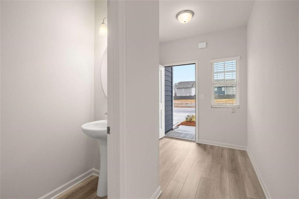 9452 Maple Grv Lane Jonesboro, GA 30238 - Photo 6 of 23 a view of a hallway with wooden floor and closet
