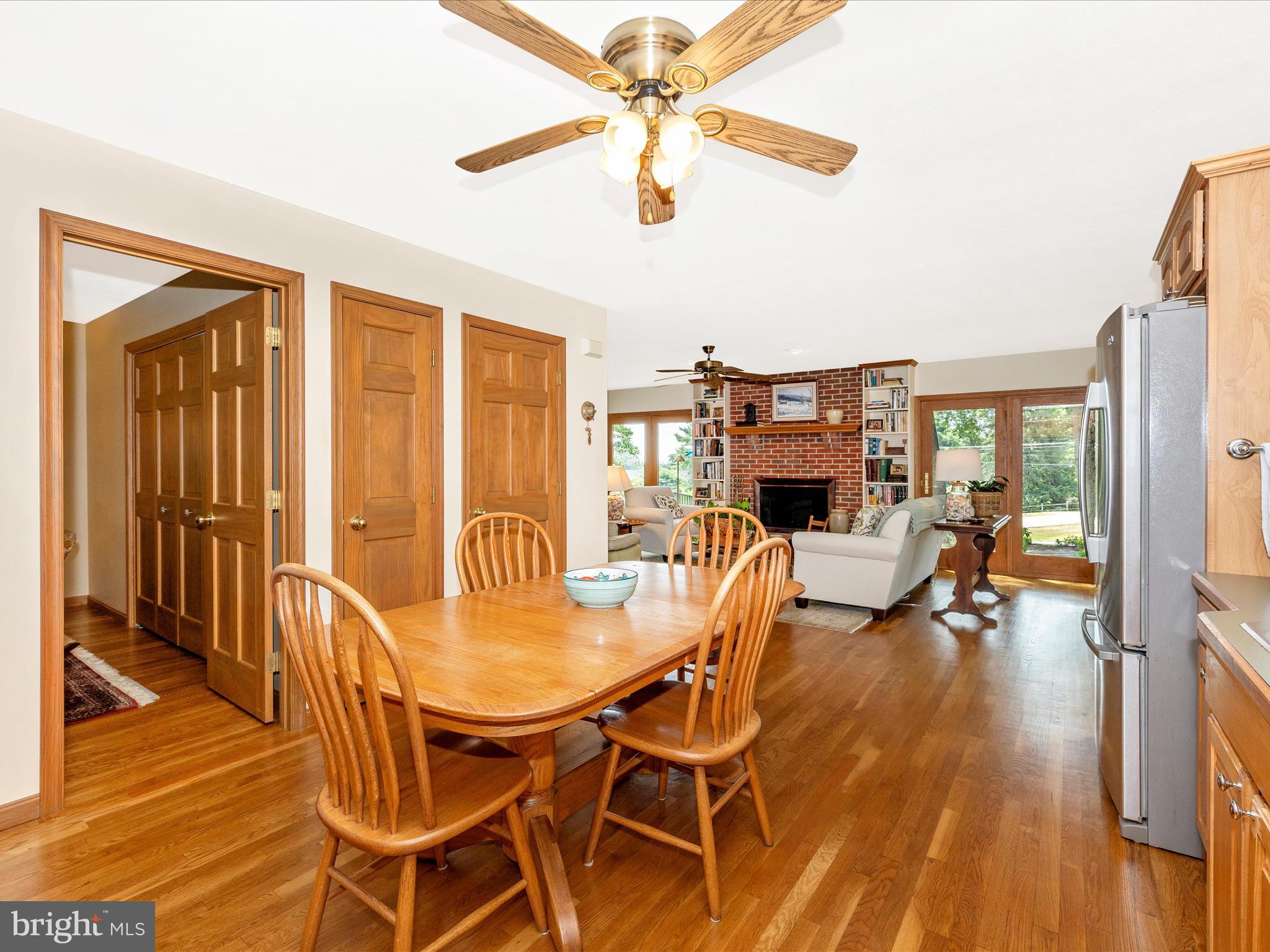 8560 Rocky Springs Road Frederick, MD 21702 - Photo 15 of 50 a dining room with furniture a chandelier and wooden floor