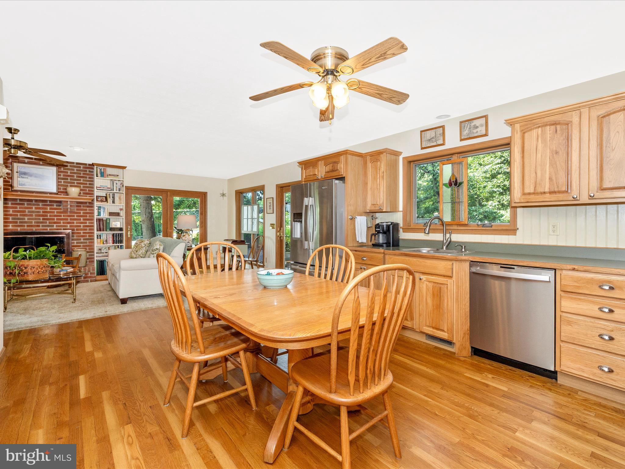 8560 Rocky Springs Road Frederick, MD 21702 - Photo 16 of 50 a dining room with furniture a fireplace and wooden floor