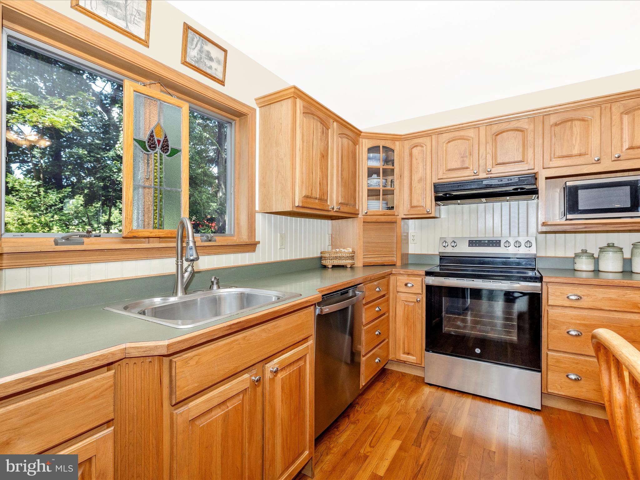 8560 Rocky Springs Road Frederick, MD 21702 - Photo 17 of 50 a kitchen with stainless steel appliances granite countertop a stove a sink and a microwave