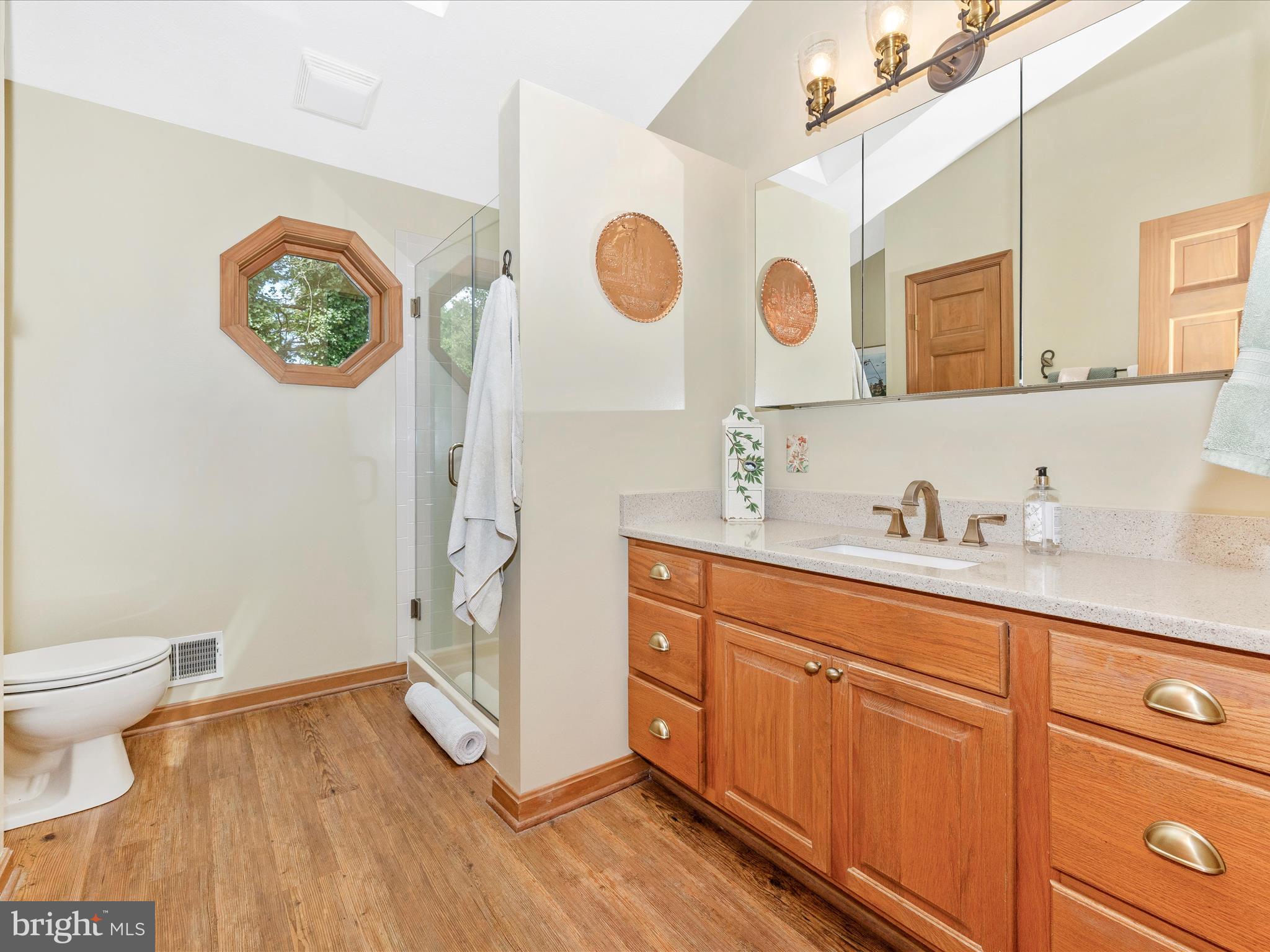 8560 Rocky Springs Road Frederick, MD 21702 - Photo 36 of 50 a bathroom with a sink a toilet and a mirror