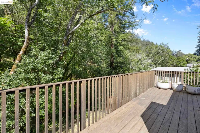 a balcony with wooden floor and fence