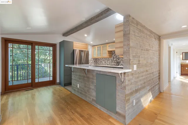a kitchen with stainless steel appliances granite countertop a stove and a refrigerator