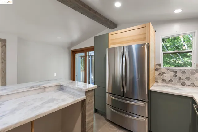 a view of a refrigerator in kitchen and wooden floor