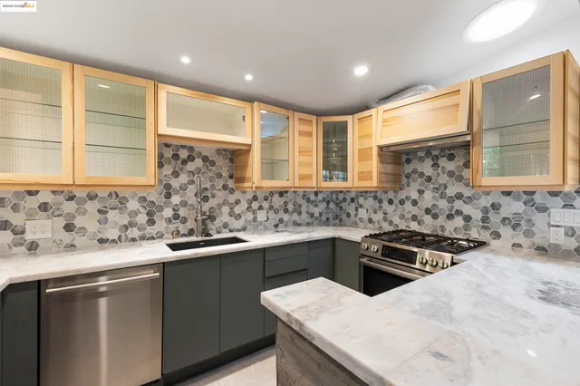 a kitchen that has a sink and a stove in it