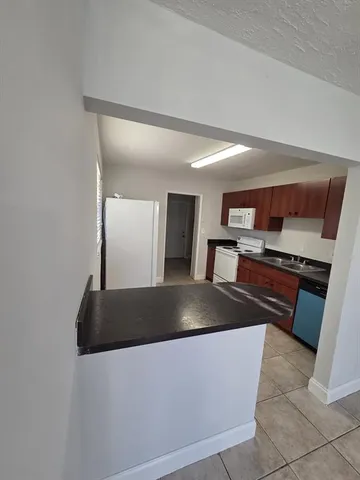 a kitchen with stainless steel appliances granite countertop a sink and a stove