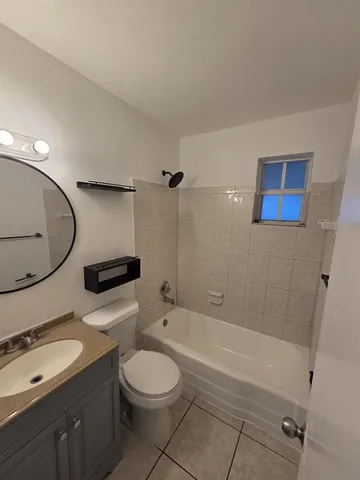 a bathroom with a toilet a sink and bathtub
