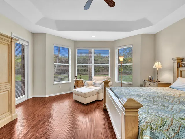 a bedroom with a bed television and a window