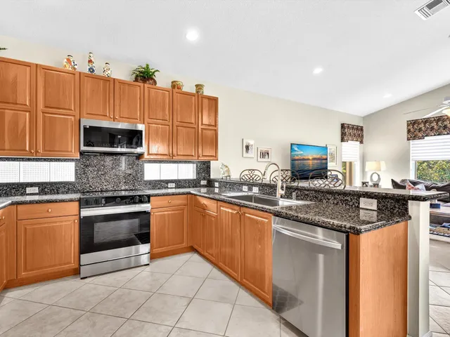 a living room with furniture a large window and a chandelier
