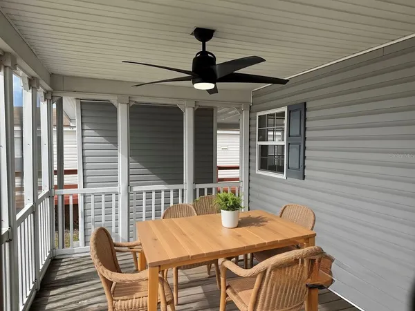 a table and chairs in patio of a house