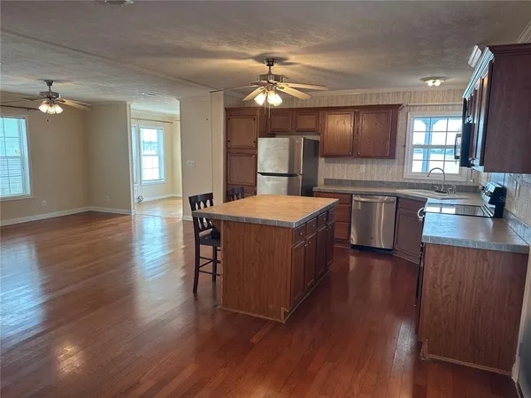 a large kitchen with a table and chairs